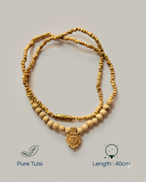 Wooden bead necklace with a gold-toned decorative pendant on a light background, shown in an overhead view