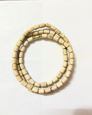 Light wooden bead necklace/bracelet with rectangular beads and a small gold clasp, laid on a white surface.