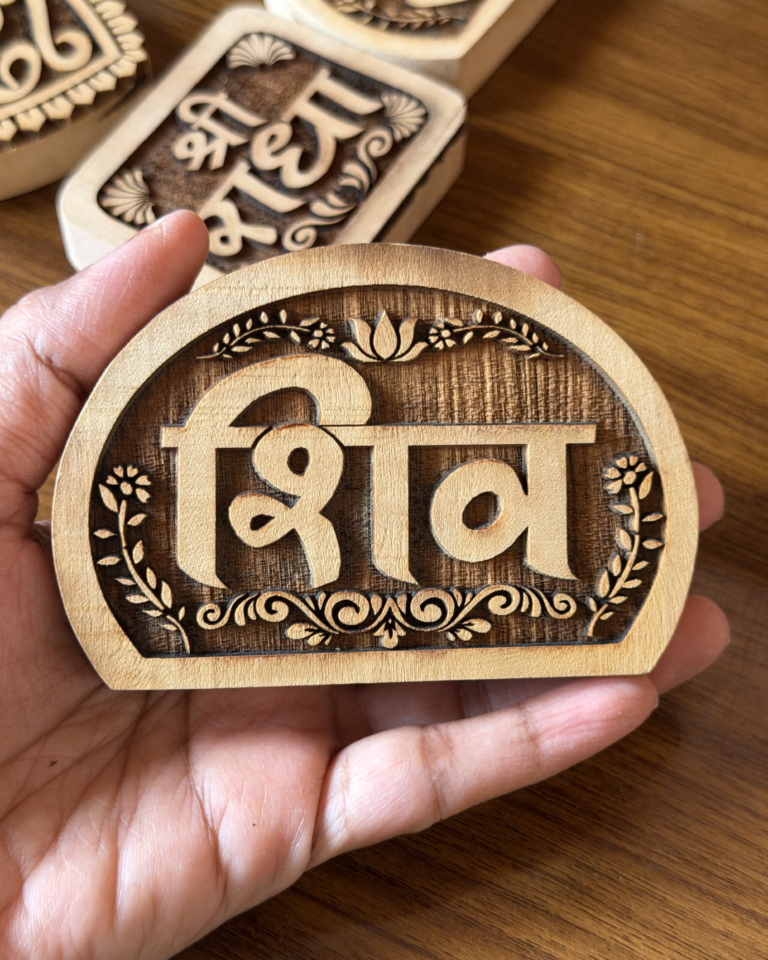 Close-up of a hand holding a round wooden token with the carved number 69 and a floral border; blurred decorative wooden pieces in the background.